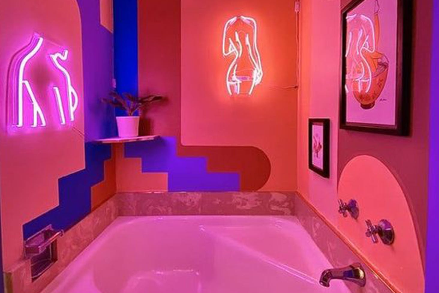 Bathroom with neon pick lighting and neon art of women's bodies on the wall.